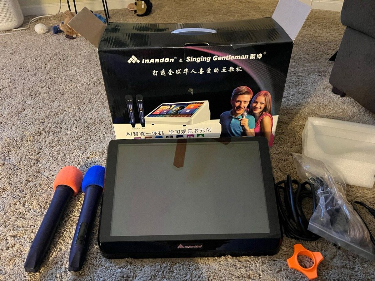 Competitor karaoke system with complicated setup, multiple components, and cluttered accessories